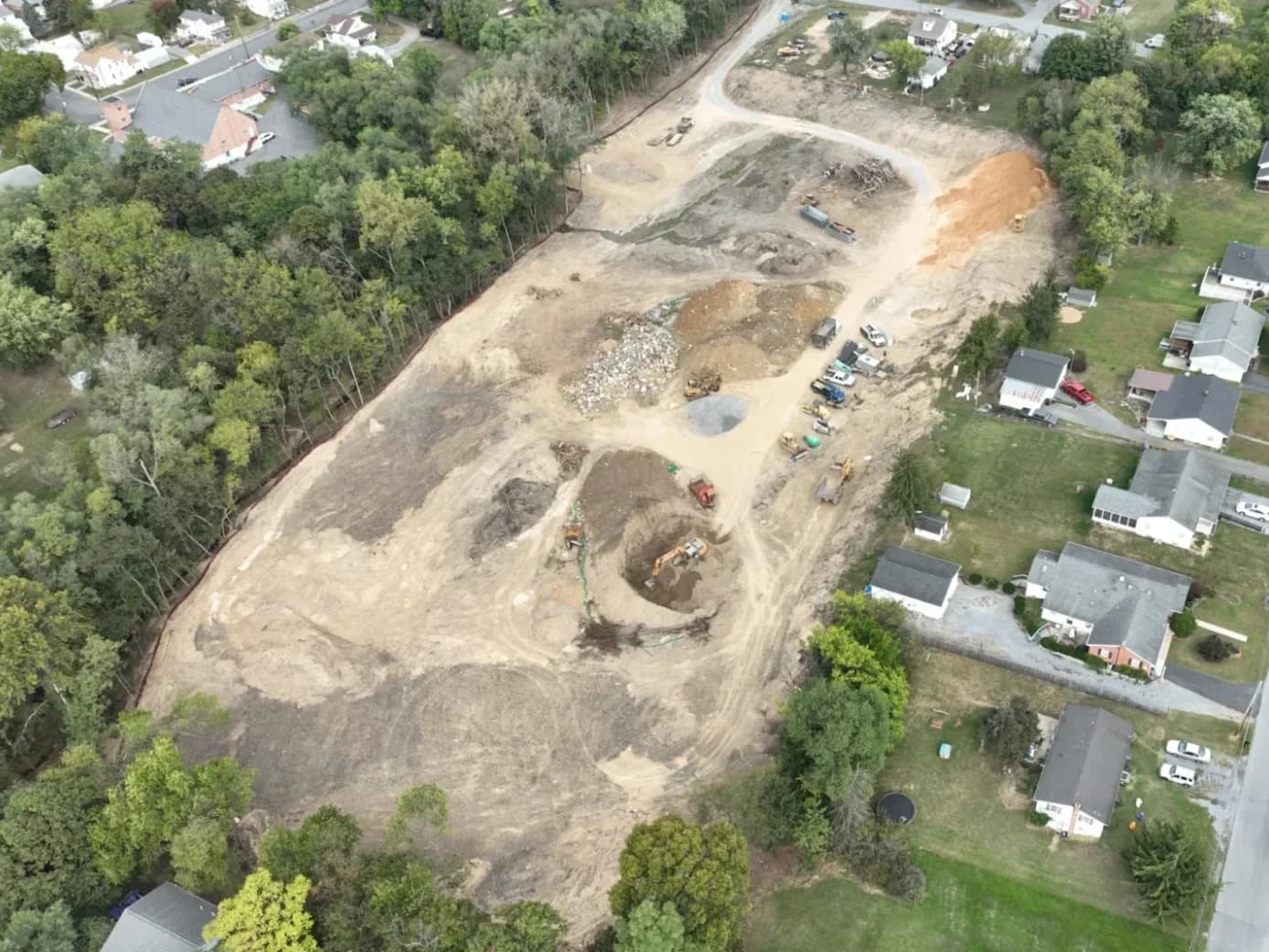 Aerial of a large excavation and site-work project with stockpiles and equipment