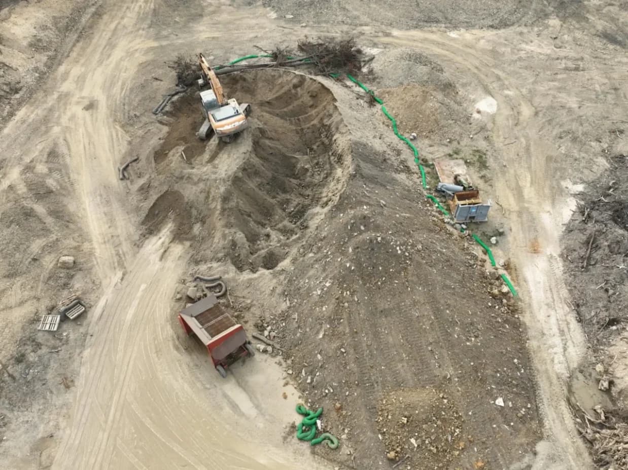 Top-down view of an excavator working an excavation site